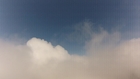 RC Model Plane punching through the clouds